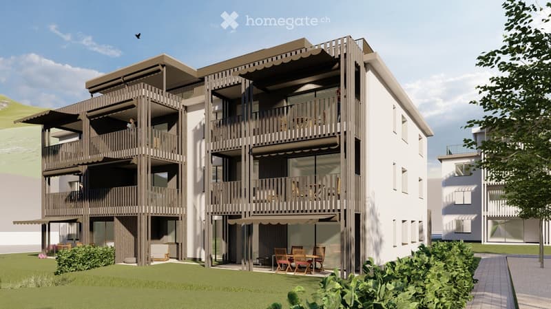 Three story building, white and brown exterior, balconies, awnings, dining tables and chairs, green lawn