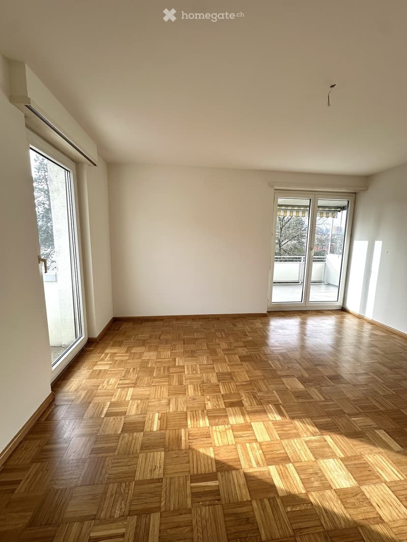Empty room, wooden floors, sliding glass doors, balcony