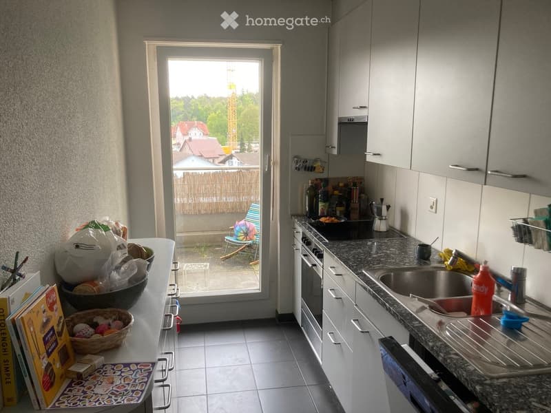 kitchen with countertop, cabinets, oven, stove, sink, balcony