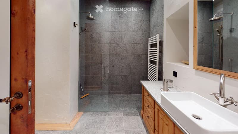 walk-in shower, vanity with sink, cabinet, mirror, towel rack