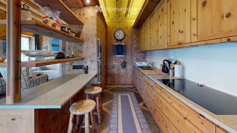 wood cabinets, counter, refrigerator, stove, sink, bowls, clocks, picture frame, rug, stools