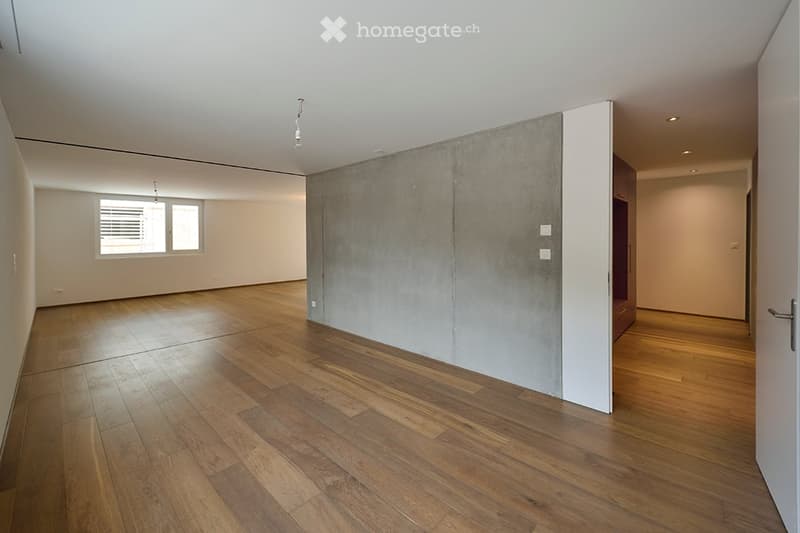 empty room, hardwood floors, concrete wall, window, open door