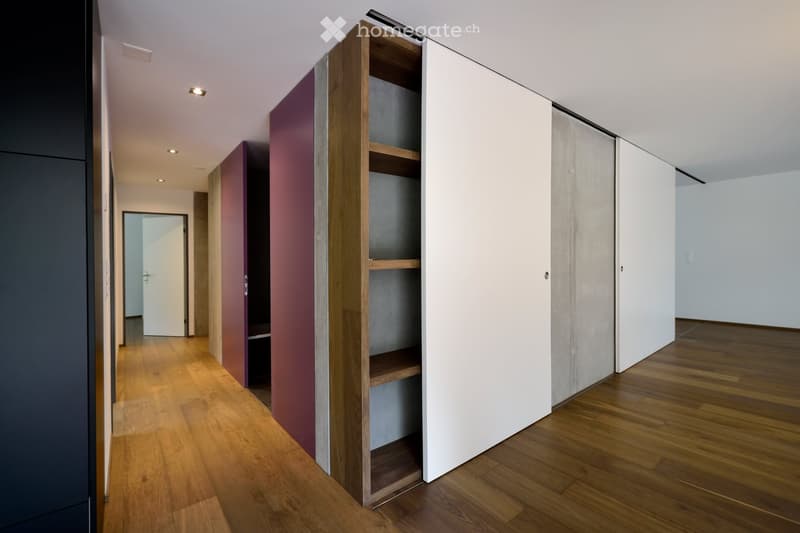 wooden floor, sliding doors, open closet, white walls, wooden shelves