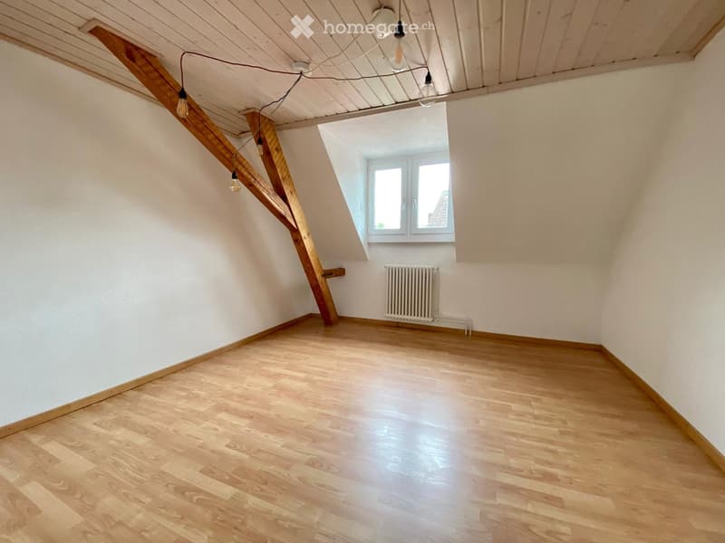 Wooden beams, wooden floor, white walls, glass window, radiator
