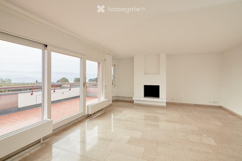 Bright, modern living room with large glass sliding doors leading to a balcony, tiled floor, and a television on a white console.
