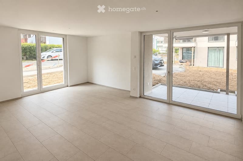 Empty room with tiled floor, large sliding glass doors leading to a patio area, white walls, and visible electrical outlets.