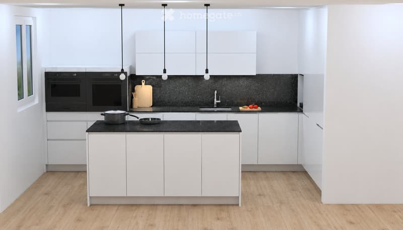 Modern kitchen with white cabinets, black countertops, and stainless steel appliances. Features include an island, pendant lights, and a window with a view.