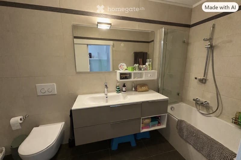 Modern bathroom with a double sink vanity, toilet, bathtub, mirror, and various toiletries. The space features beige tiles, a glass shower enclosure, and a towel on the edge of the tub.