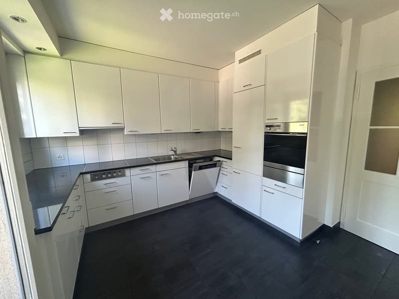 modern, clean, white cabinets, black countertops, stainless steel appliances, dishwasher, washing machine