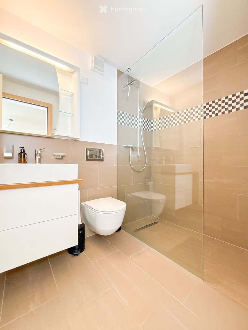 glass wall shower, white wall, white sink, modern fixtures, toilet, tiled floor