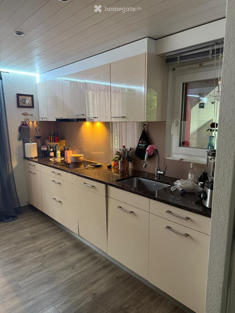 {"type": "Kitchen", "objects": ["sink", "faucet", "blender", "bowl", "fridge", "cupboard", "bottle", "framed picture", "towel", "faucet", "fridge", "cupboard", "cupboard", "cupboard", "cupboard", "cupboard", "cupboard", "cupboard", "cupboard", "cupboard",