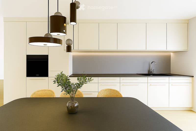 Modern kitchen with white cabinets, pendant lights, a dark countertop, and a small plant on the table.