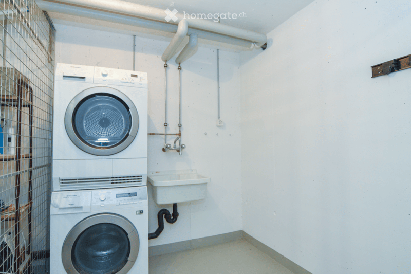 Compact bathroom with a washing machine, dishwasher, and a small sink.