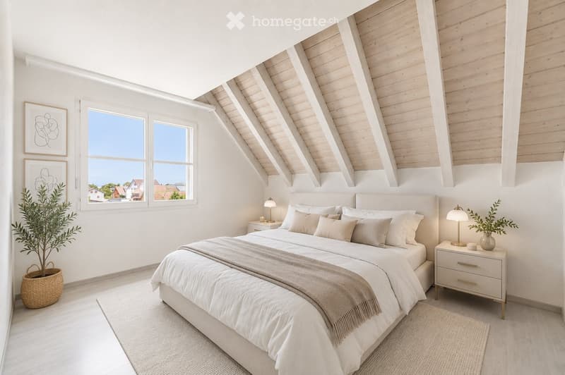 Bright, airy bedroom with a large bed, nightstands, lamps, and artwork on the walls. The room features wooden slanted ceilings and large windows offering a view of the outside.