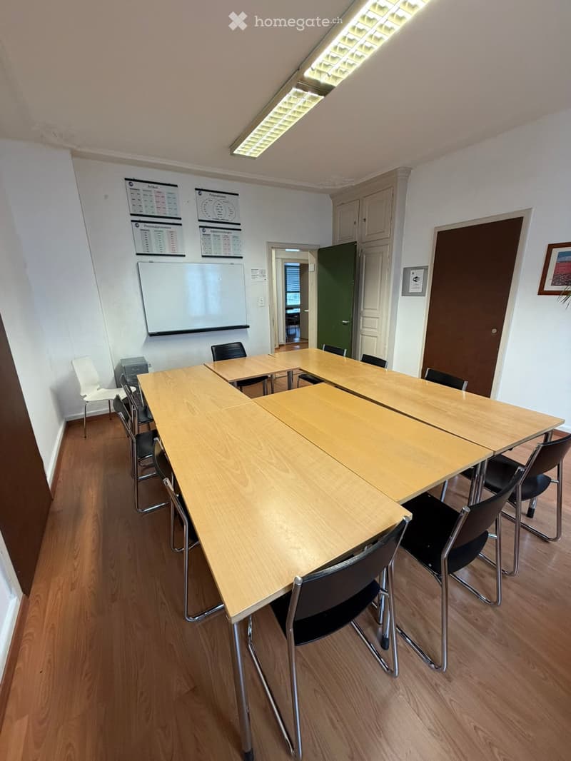 wooden desk, chairs, wooden floor, whiteboard, closed door