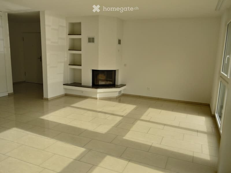 Empty room with tiled floor, white walls, built-in fireplace, and built-in shelves.