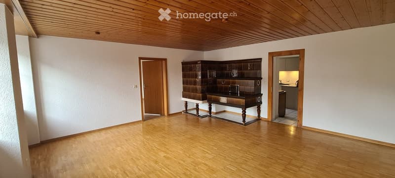 Fireplace in the corner, large wooden desk, door, large windows, large wooden cabinets