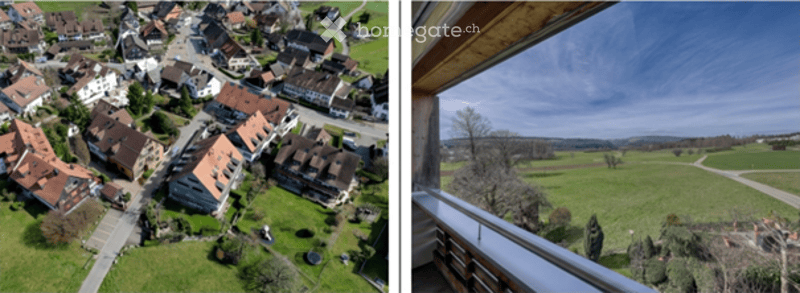 A balcony overlooking a scenic countryside with rolling hills and a village below. The view includes green fields, scattered trees, and a distant settlement with traditional houses.