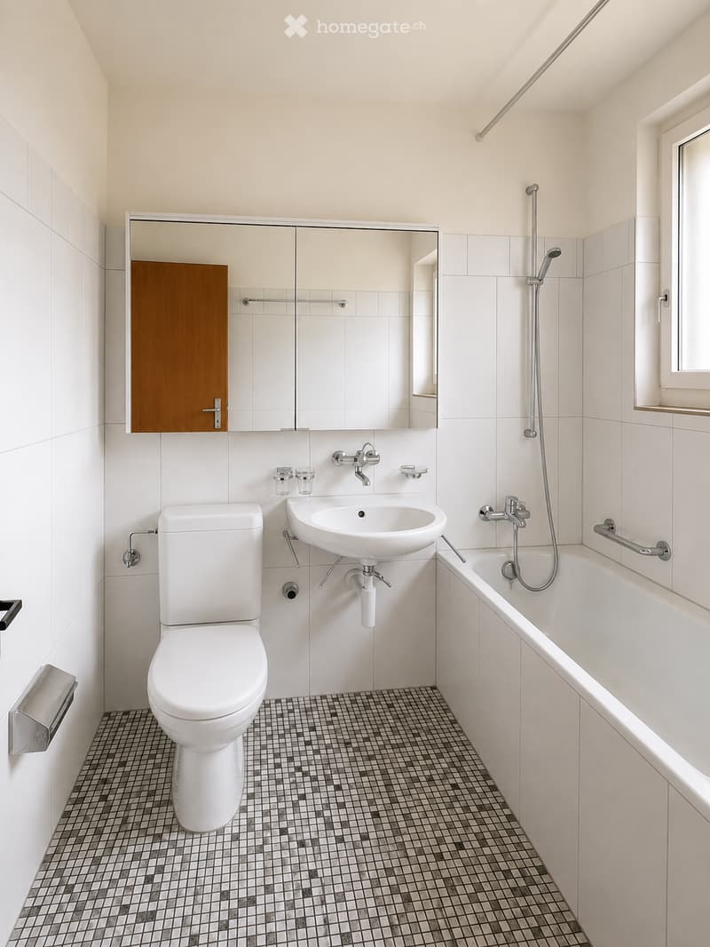 Modern bathroom with white tiles, a toilet, a sink, a bathtub, a mirror, and a wooden cabinet.