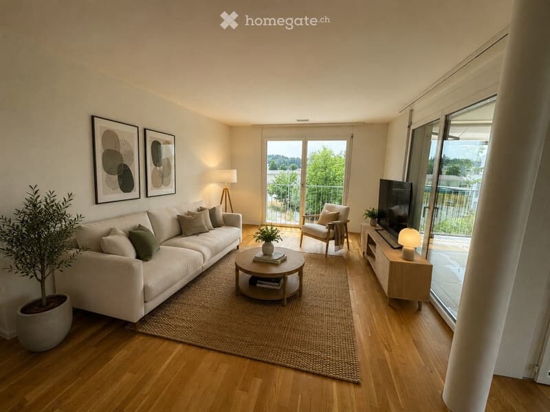 Modern living room with light wooden flooring, a large sectional sofa, coffee table, armchair, TV, and large windows opening to a balcony.