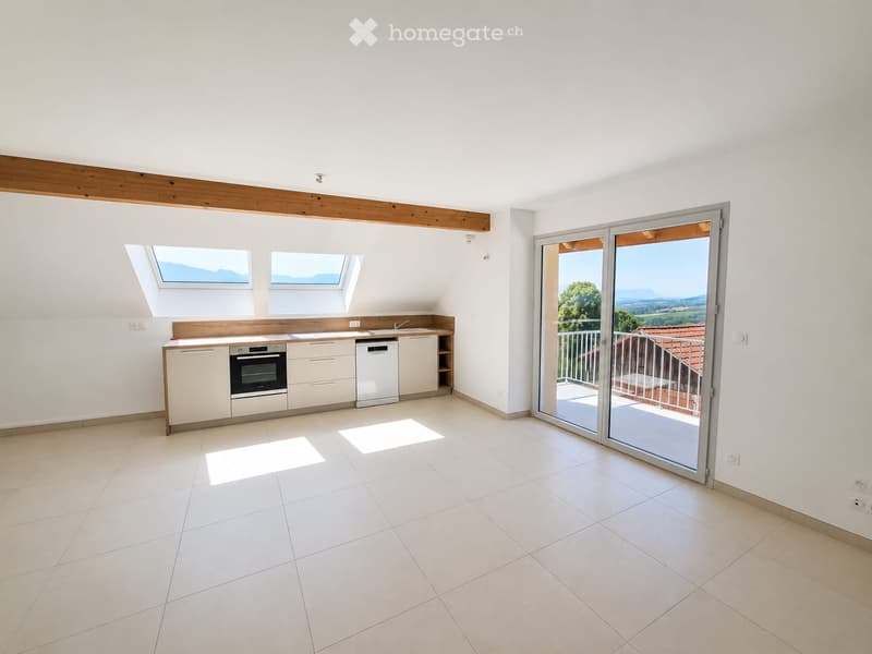 Modern kitchen with white cabinets, an oven, dishwasher, and a sink, featuring large windows and a sliding glass door leading to a balcony with a scenic view.