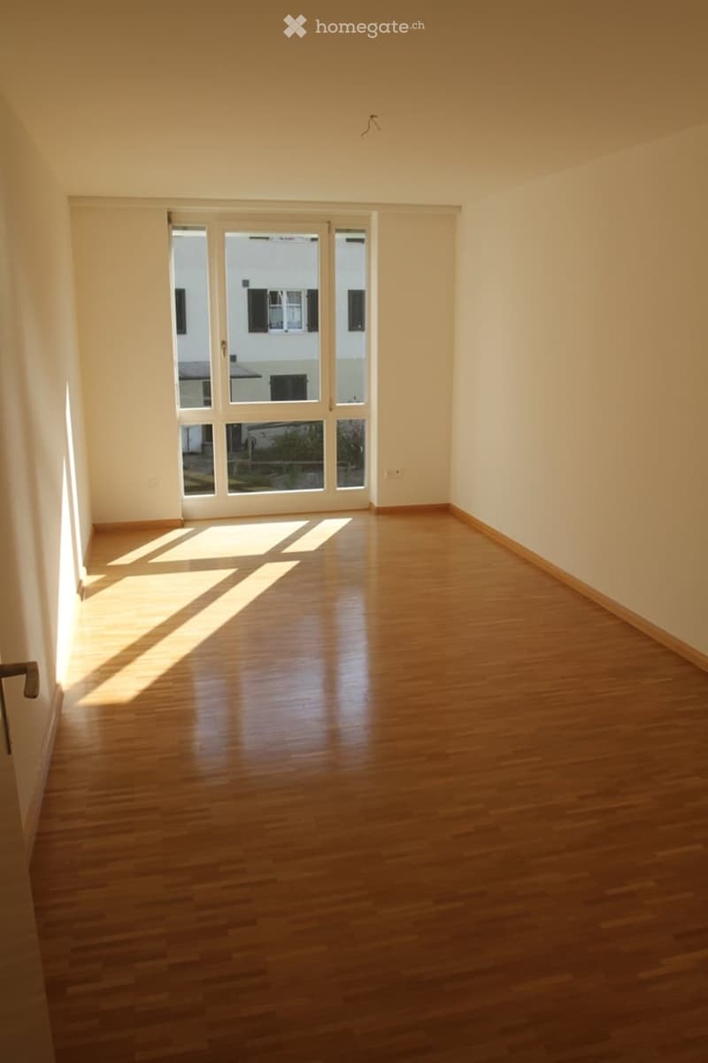 empty room, wooden floor, large glass windows with balcony, white walls