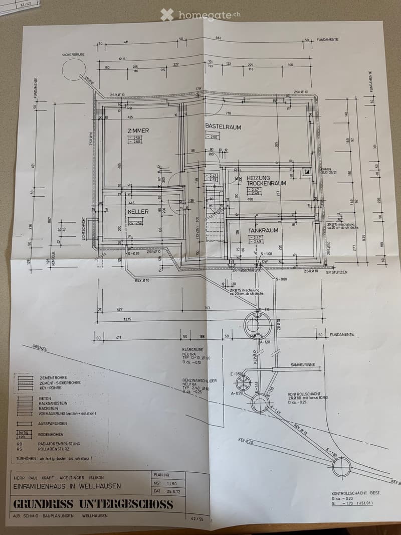 Floor plan of a basement level showing rooms including a cellar, heating room, tank room, and basement space, with detailed measurements and structural elements.