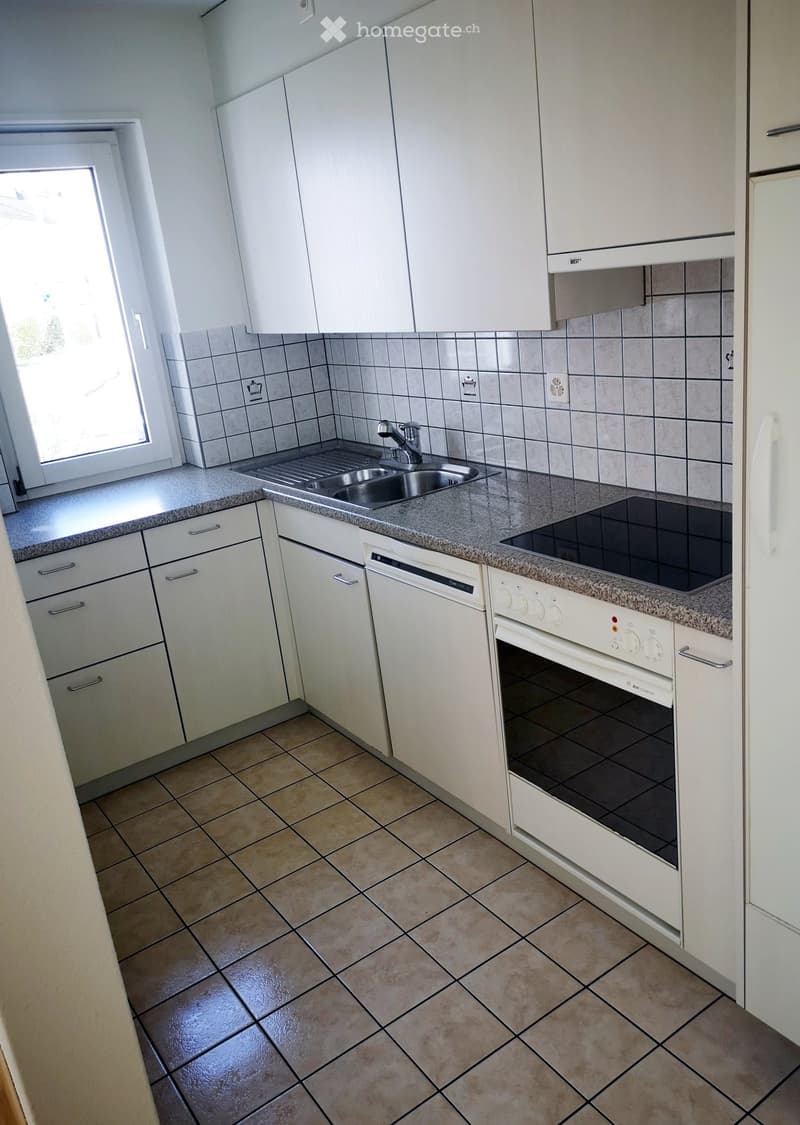 Tiled floor, gas stove, oven, dishwasher, sink, cabinets, power outlet, natural light from the window