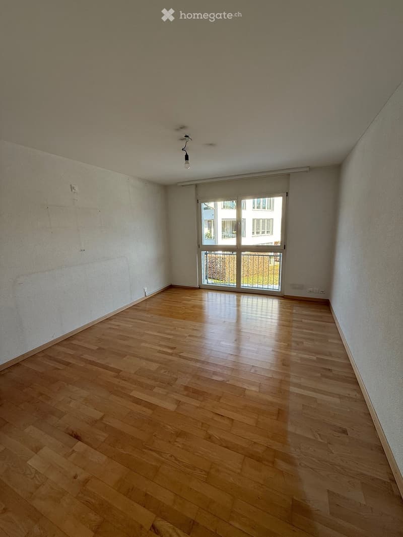 Hardwood floor, sliding glass door to balcony, power outlets, light fixture