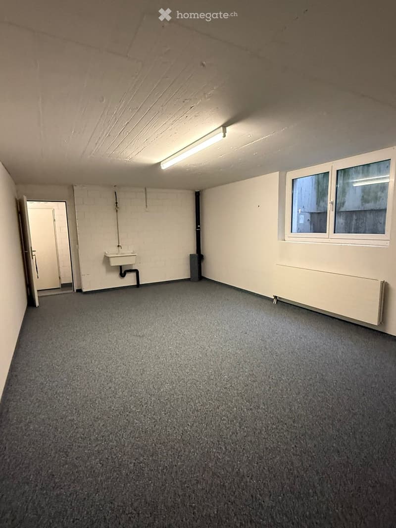 empty room, white walls, gray floor, window, radiator, sink, open door