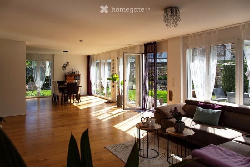 wooden floor, large windows, balcony, dining table, couch, side tables, plants, chandelier