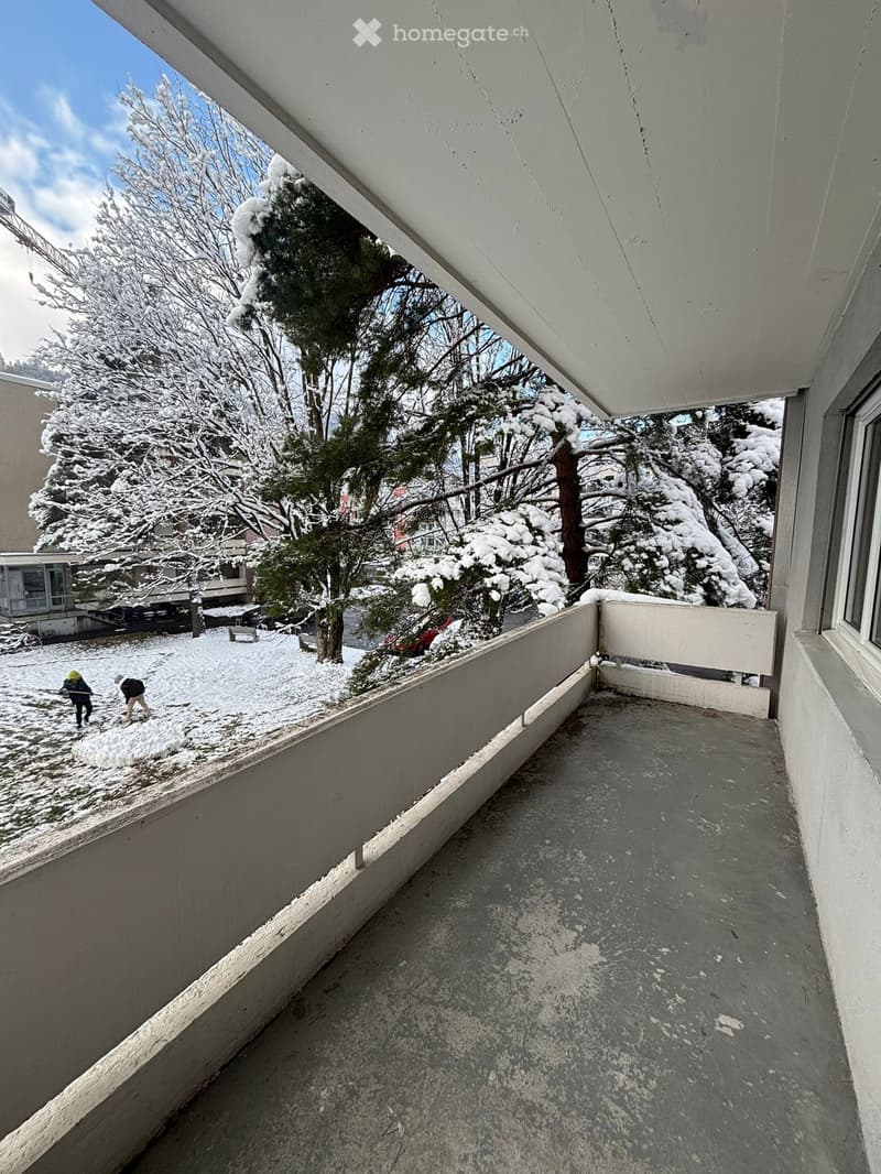 empty balcony with a railing and snow on the ground