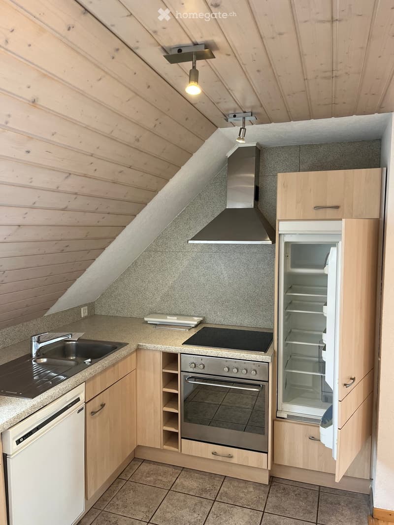 Modern kitchen with light wooden cabinets, stainless steel appliances, granite countertops, and a range hood. Features include a sink, oven, refrigerator, and dishwasher.