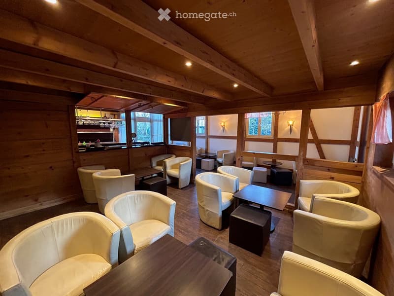 leather armchairs, wooden tables, wooden bar counter, wooden ceiling