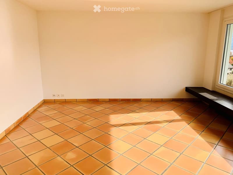 Unfurnished Room. Empty room with tiled floor and white walls, featuring a window and electrical outlets.