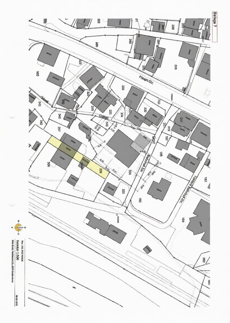 Floor plan of a residential area showing multiple buildings and plots with labeled streets and property boundaries.