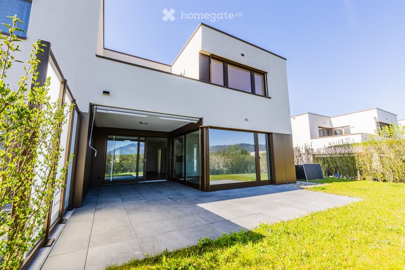modern house, white exterior, large glass doors, balcony, paved entrance, green lawn