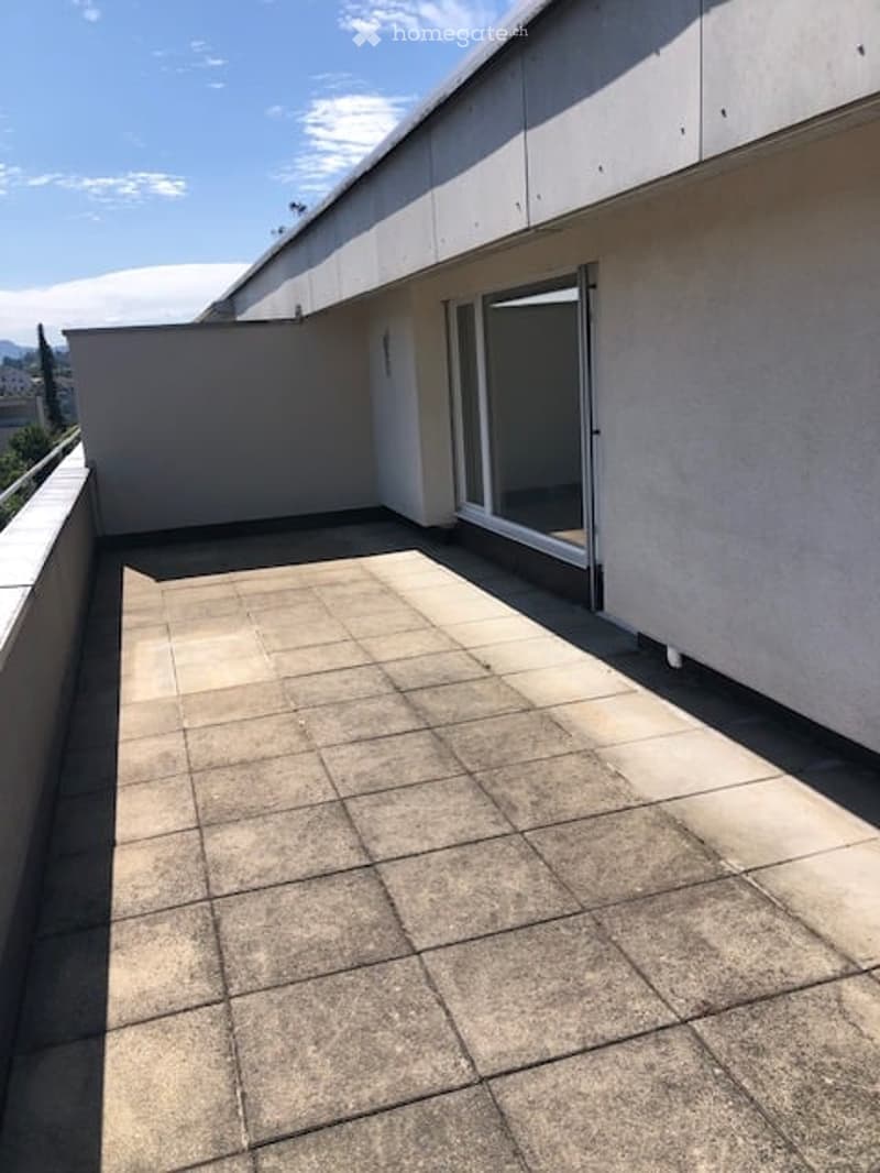 Balcony with tile flooring and an open door leading to a room