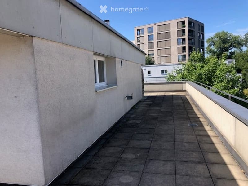 Empty balcony with tiled floor, a window, and a metal railing