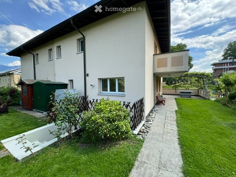 {"visible_features": ["Garden / Outdoor Area"], "type": "House", "objects": [], "description": "Two-story house with white exterior, multiple windows, and a well-maintained garden with a bench and patio area.", "localized_descriptions": {"EN": "Two-story