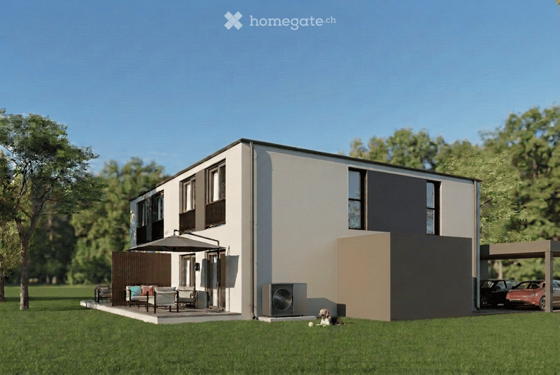 Modern two-story house with a garage, parking area, and outdoor seating area with chairs and a table.