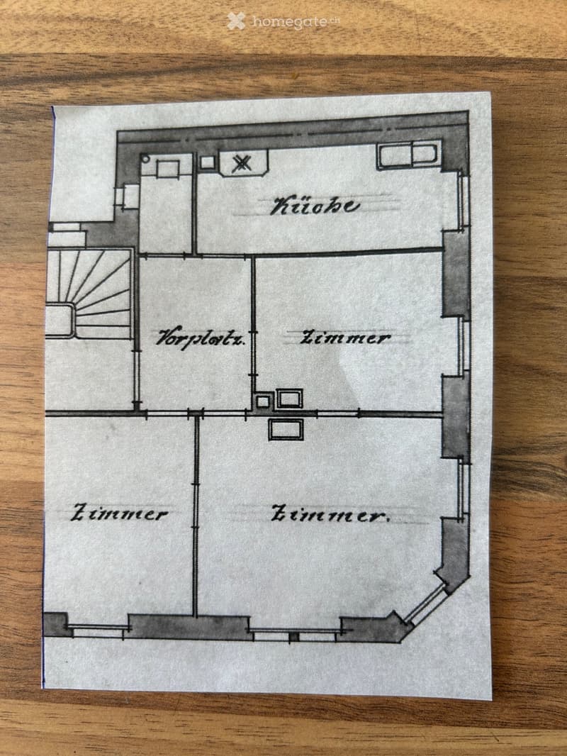 Floor plan showing a kitchen, hallway, and three bedrooms.
