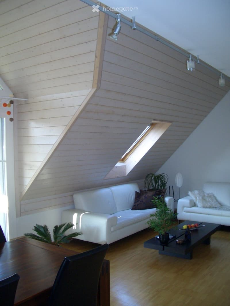 Modern living room with white sofas, coffee table, dining table, and plants. The room features wooden flooring and exposed wooden beams on the ceiling.