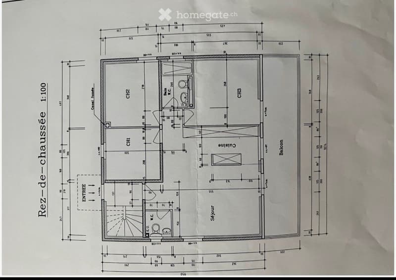 Floor plan of a ground floor showing a living room, kitchen, two bedrooms, two bathrooms, and a balcony.