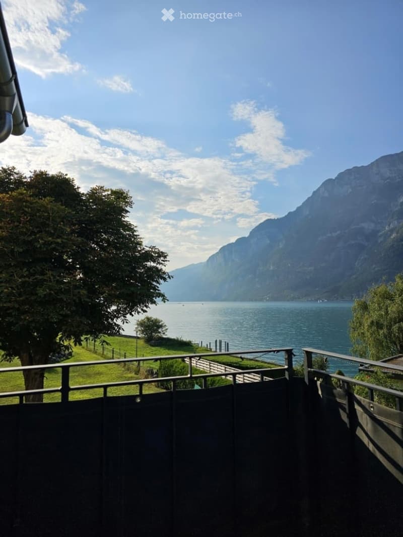balcony overlooking a lake and mountains