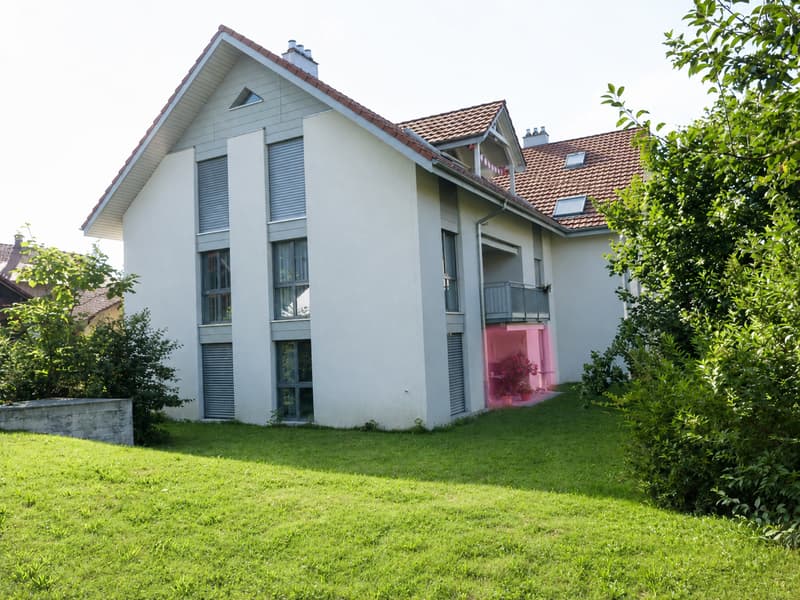 Two-story modern house with white walls, red-tiled roof, multiple windows, and a small balcony with a potted plant.