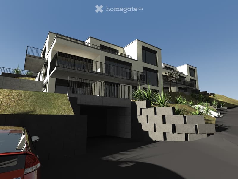 Modern multi-story residential building with balconies, surrounded by landscaped greenery and a raised ground floor entrance.