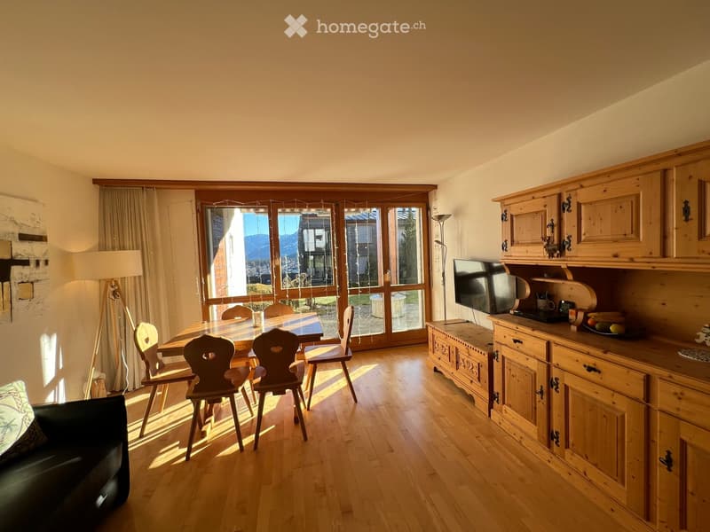 dining room, wooden flooring, large window, wooden dining table and chairs, TV, wooden cabinet, lamp, black couch, pillow