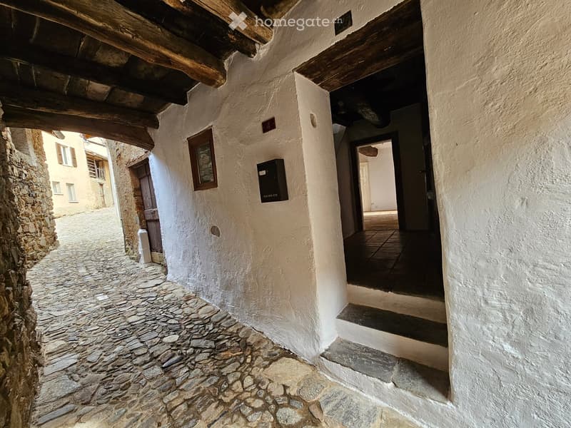 stone cobblestone street, whitewashed wall, entryway, wooden door, window