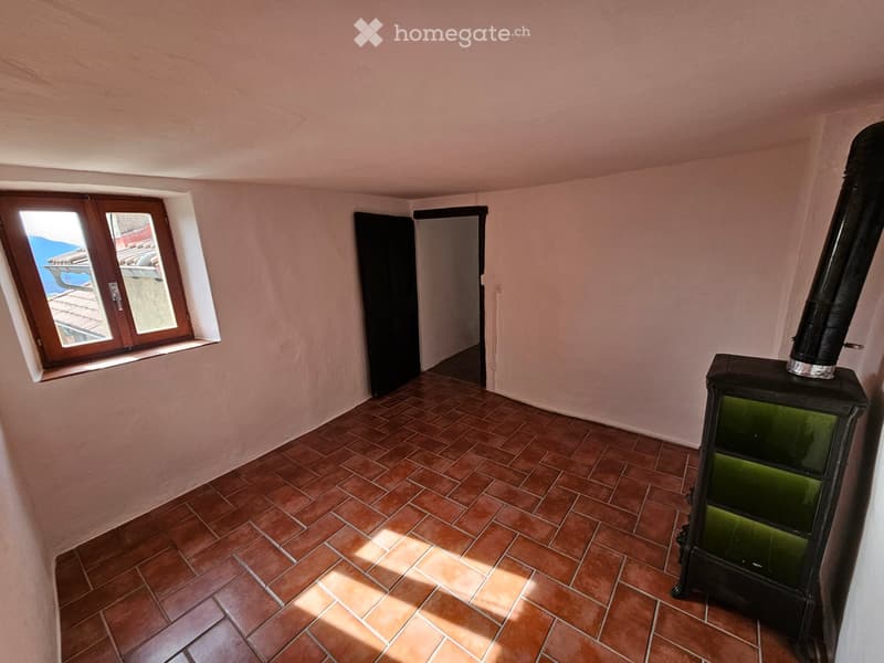 empty room, tiled floor, a fireplace, two doors, window